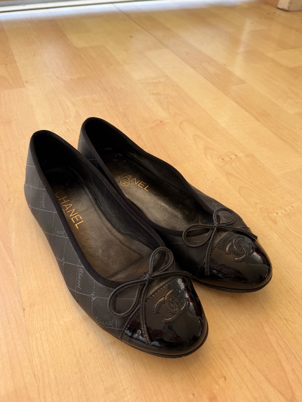 CHANEL Black Quilted Logo Cap-Toe Ballet Flats